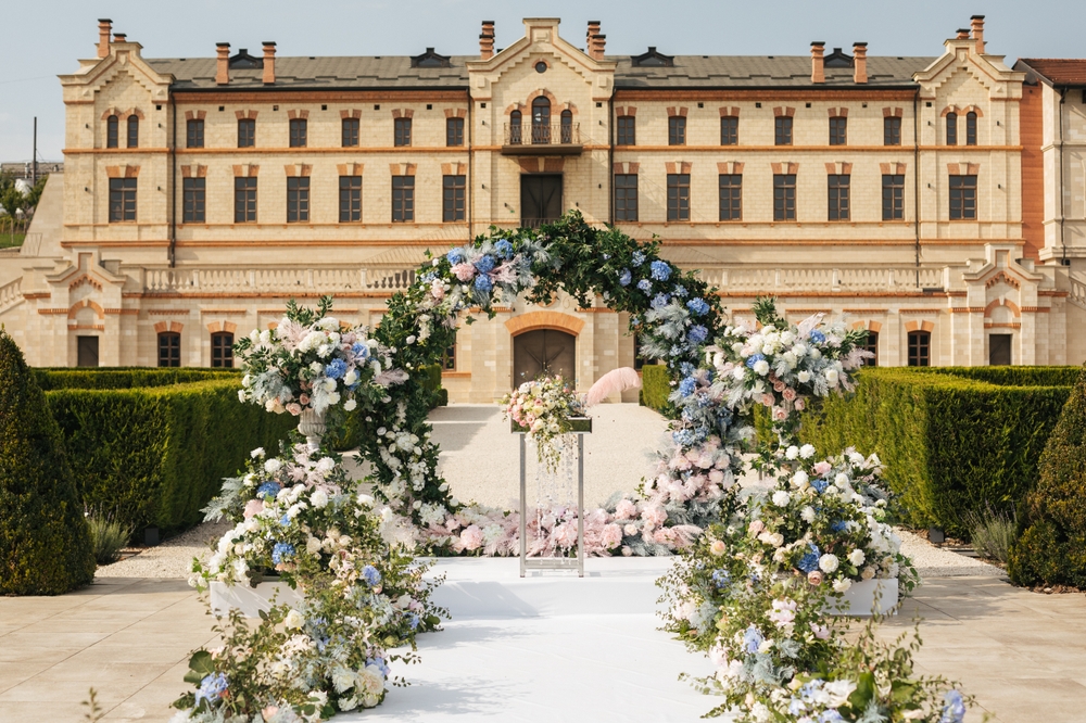 Hochzeit vor einem Schloss um Garten.